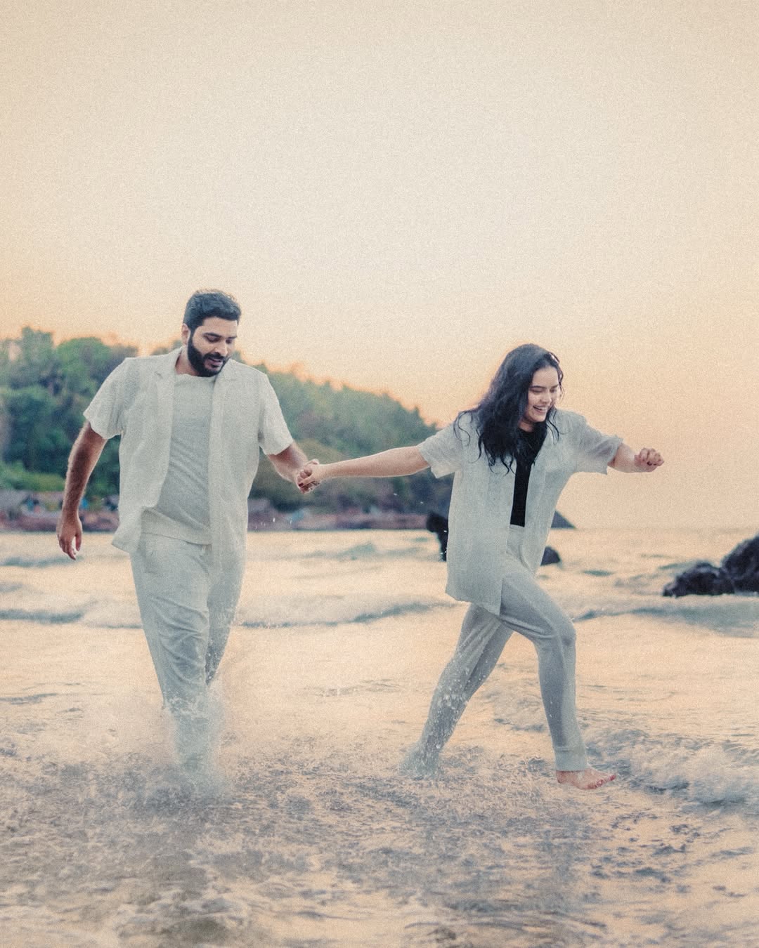 Couple by the ocean during their coastal wedding celebration